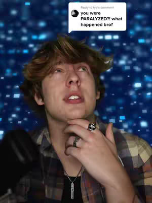 A young man looks upwards with concern, a speech bubble with a question appears above his head. The background is a blurred field of blue squares.