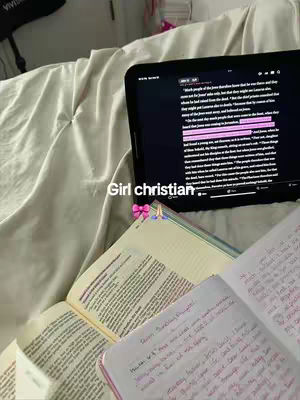 The image shows a person studying books on a bed, with a tablet displaying text and a notebook open. The setting suggests a casual study setting.