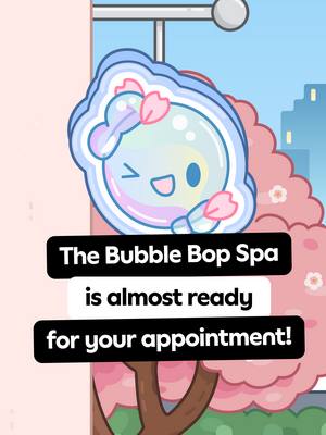 The image is a cartoonish illustration set in a spa environment, featuring a central character. The main element is a light blue bubble-shaped character with a smiling face and winking eye, adorned with reddish-pink blossom-like features. The background includes what appears to be a pink tree or large shrub. Below the character are two black rectangular text boxes with white text proclaiming "The Bubble Bop Spa" and "is almost ready for your appointment!". In the background a window offers a glimpse of a cityscape and sunlight. The overall composition is bright and cheerful with a clean, cartoon style.