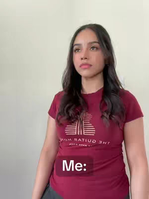 A young woman with dark hair and a burgundy t-shirt is the focus. The background is a pale neutral color. The overlay text "Me:" is placed on the lower center of the image.