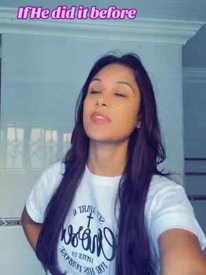 A woman with long, dark hair is looking up with her eyes closed. She is wearing a white t-shirt with a logo that is partially visible. The background is a light blue and has a text overlay.