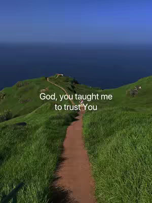 A scenic cover image featuring a verdant, rolling hillside leading towards a body of water, likely the ocean, under a clear blue sky. A dirt path meanders up the hillside, guiding the viewer's eye toward the top of the hill, where a small structure is visible. The overall composition is natural and evokes a sense of peace and tranquility.
