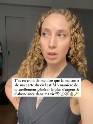 A woman with curly blonde hair looks slightly off-camera with a questioning expression, set against a blurred, neutral-toned background. Text overlayed in a white rectangle contains phrases about understanding one's 'house 2' in a birth chart and its relation to finances and abundance.