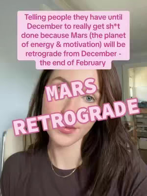 A woman with long brown hair and blue eyes is the focus of the image. Text overlays in a pink hue are placed on the image. There is a text box above her head with the text "Telling people they have until December to really get sh*t done because Mars (the planet of energy & motivation) will be retrograde from December - the end of February." A second text overlay, "MARS RETROGRADE", is angled across her face.