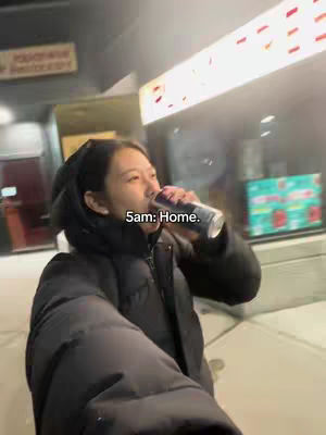 A selfie shot shows a person drinking from a can, likely a beverage, in a dimly lit outdoor environment. The person is wearing a dark jacket, and the image includes a caption overlay.