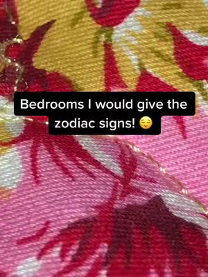The cover image shows a close-up of a patterned fabric with a black rectangular text overlay. The fabric has a blend of red, pink and gold colors. The text overlay says, 'Bedrooms I would give the zodiac signs!'