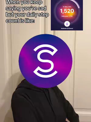 A person wearing a black hoodie, with a large purple circle covering their face. A screenshot of a fitness tracker showing steps and a daily goal is in the top right corner. White text is overlayed on the image discussing the person's step count and how they should go for a walk.