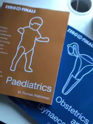 The image shows two textbooks with different colored covers. The left book is orange with a white outline of a child running. The text 'ZERO FINALS' appears at the top. The blue textbook on the right has a stylized image of what appears to be a fetus. The text 'ZERO FINALS' is found on top.
