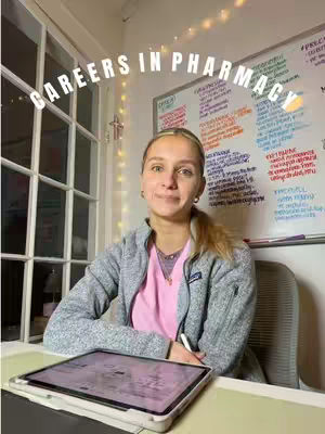 A woman in a gray jacket and pink top sits at a desk with a tablet, a whiteboard covered with notes is in the background. The text "CAREERS IN PHARMACY" arches above the woman.