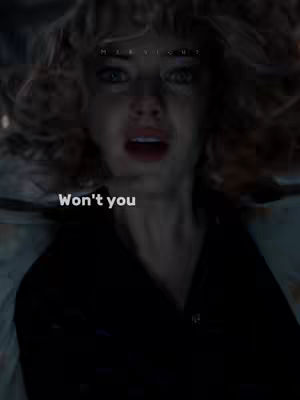 The image shows a close-up of a distressed woman with blonde, curly hair. Her face is contorted in a look of fear or distress, with wide eyes and an open mouth, as if she is about to cry or is in shock. The background is dark and blurry, which further emphasizes her expression. The text overlay "Won't you" is placed in the bottom left of the image.