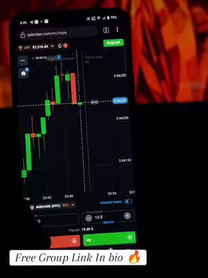 A mobile phone displays a trading platform with a candlestick chart. The interface is dark, showing green and red bars representing price movements, and includes options to "Deposit" and "Trade". The background is a blurred mix of red and dark tones, and a text overlay prompts viewers to join a free group chat.