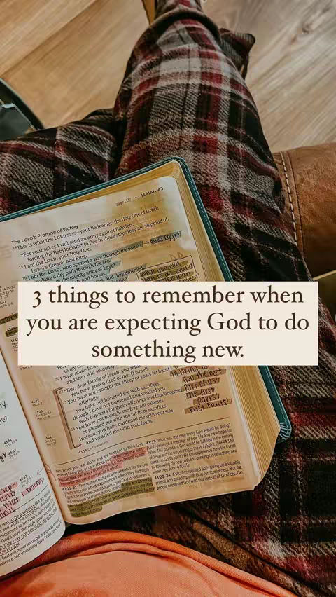 The image shows an open Bible resting on someone's lap. The Bible is open to a page with highlighted text, and the person's plaid-covered legs are visible. A rectangular text overlay in the center reads, "3 things to remember when you are expecting God to do something new."