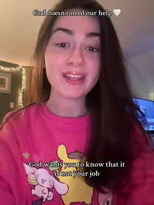 A young woman with long brown hair and a pink t-shirt is looking at the camera and speaking. Above her head is white text. Below her is more text.