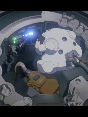 The cover image presents a detailed, close-up view of machinery and a figure from the anime Ghost in the Shell. The scene is primarily cool toned, with grays and blues dominating the color palette. A white, helmet-like structure with multiple dark spots is prominent, positioned centrally and slightly tilted. Metal framing and mechanical components surround this figure, with some sections appearing rusted or worn. The composition is enclosed and intricate, creating a sense of being inside a confined space, with a slight blur adding depth.