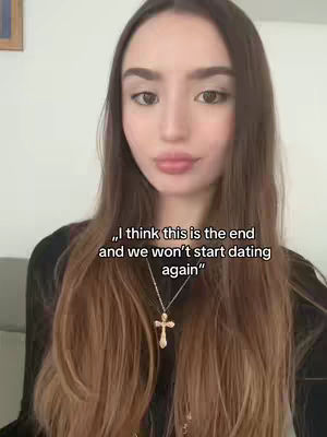 A woman with long, dark brown hair looks directly at the camera against a light background. Overlaid on her are the words "I think this is the end and we won't start dating again". She wears a necklace with a cross pendant.