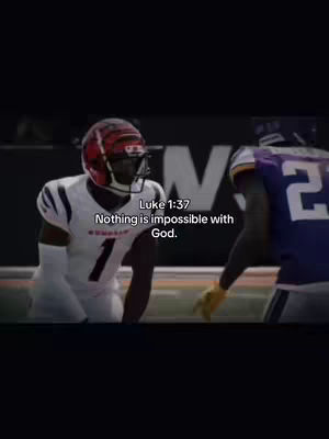 An image from a football game has overlaid text quoting Luke 1:37, 'Nothing is impossible with God.' Two football players are visible, one wearing a white jersey with a black and red helmet, and the other in a purple uniform. The background is dark with the word 'N' visible.