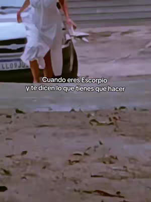 A woman in a white dress walks away from a car on a beach, text overlayed, with blurred background.