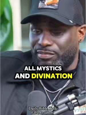 The cover image features a close-up of a Black man wearing a black baseball cap with a logo, a dark jacket, and a silver chain. Text overlays include 'ALL MYSTICS AND DIVINATION' in bold white letters with a yellow highlight and 'Daily Bible Talk / False Prophets' at the bottom. A microphone and part of a Fish logo are visible, suggesting a discussion or interview setting.