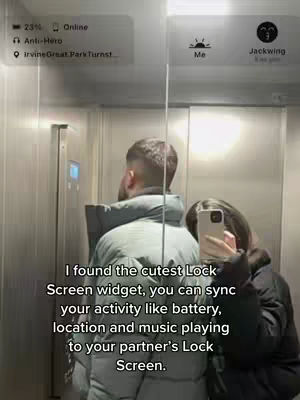 A person in a black jacket is filming a couple in the elevator . They are standing in a mirror. The photo presents the lock screen of the phone app , and text is overlaid.