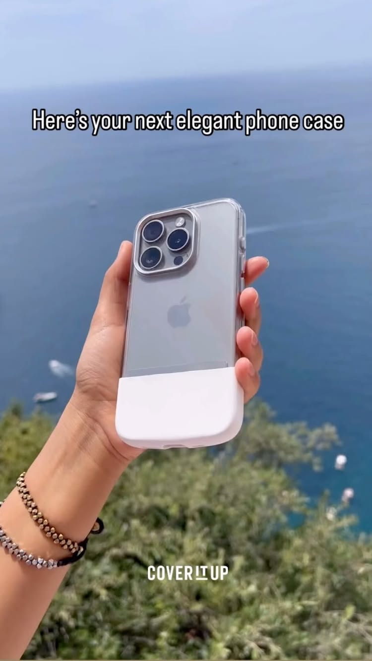 The cover image shows a hand holding a transparent phone case with a white bottom, showcasing a phone with the Apple logo. The background features a blurry view of a blue sea and sky, with green trees in the foreground. Text overlayed on the image reads, 'Here's your next elegant phone case.' The overall composition is bright and focuses on the phone case.