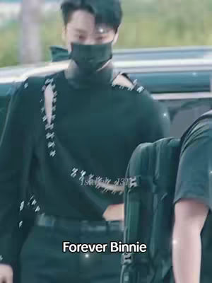The cover image shows a person wearing a black mask and a dark green top. "Forever Binnie" is written in white letters on the black background.