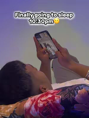 The cover image shows a person lying in bed, holding a smartphone with an active screen. The person's face is partially visible, with a focus on their hair. The background is a gradient of purple and blue.