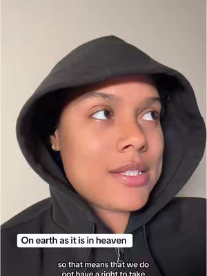 A woman with dark hair wearing a black hoodie is looking off to the side, a text overlay provides context about heaven and earth.
