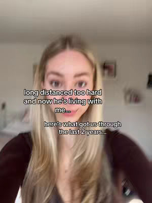 A woman with long blonde hair is centered in the frame. Text overlays are placed above and below her, and the background is a blurred interior setting. The overall composition is a medium shot, focusing on the person and the text.