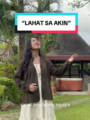 The cover image shows a young woman looking upwards with a smile, her hands slightly raised. She is situated outdoors, with lush greenery and a blurred background that showcases a gazebo-like structure. There is text overlayed at the top in a white rectangular box, as well as text at the bottom.