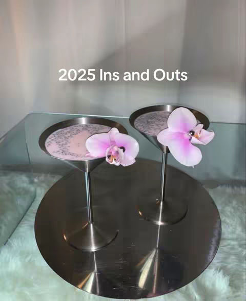 The image shows two martini glasses with pink liquid and floral decorations against a light backdrop, a circular brushed metal surface, and text overlay on the top.