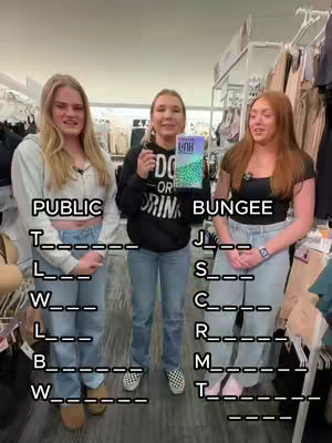 Three young women stand side by side in a retail setting, playing a word game. Text overlays on the image provide initial letters and blank spaces for word guessing.