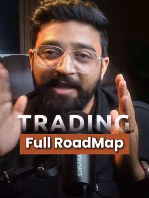 The cover image features a man with glasses, a beard, and dark hair. He is positioned centrally with his hands raised. Overlayed text reads 'TRADING' above 'Full RoadMap' in a rectangular orange box. A black microphone is in the foreground.