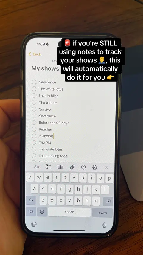 A hand holding a smartphone. The screen displays the Notes app with text and a list of shows. A black overlay with white text is positioned at the top, providing context. The background is a wooden surface.