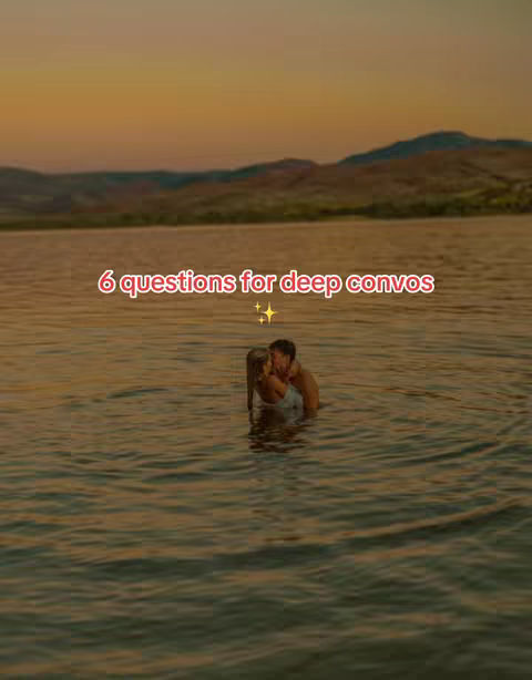 The image captures a romantic moment at sunset, with warm colors setting the tone. A couple is seen embracing and leaning in for a kiss in a lake, with only their upper bodies visible. The water reflects the sunset. Text overlayed says, “6 questions for deep convos,” with a star.