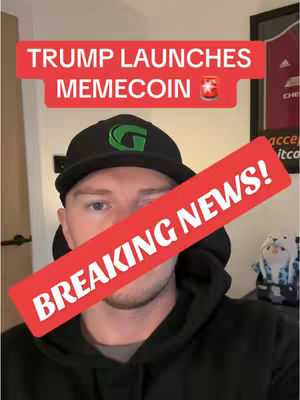 A man wearing a black hoodie and a black cap with a green logo is the central figure. A red banner across the image reads 'BREAKING NEWS!' White text on a red background near the top says 'TRUMP LAUNCHES MEMECOIN'. The background elements include a door and a framed picture.