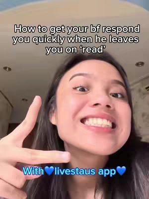 A young woman with dark hair smiles widely, holding up her hand in a peace sign with one finger pointing. Above her is text that is black font and below her is text with a blue to white gradient as well as two blue hearts. The background has an out of focus room with a light. This is clearly a selfie style video.