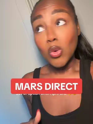 The cover image features a close-up of a woman with dark hair and fair skin. She faces slightly left, with her eyes looking up and left. Her mouth is slightly open, as if she's about to speak or is surprised. A red rectangular text overlay stating 'MARS DIRECT' is positioned at the bottom center. The background is a light, somewhat cluttered space with the top of a light-colored wall or door visible.