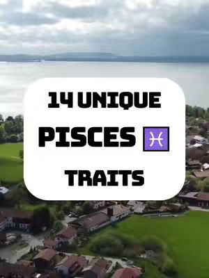 An aerial view captures a scenic landscape, likely a town or village, nestled by a large body of water, possibly a lake or sea. The sky is filled with clouds, suggesting a daytime shot with natural light. Overlayed on this image is a large, white, rounded rectangle containing the text '14 UNIQUE PISCES TRAITS' in bold, black lettering. A purple Pisces zodiac symbol is placed in between the words PISCES and TRAITS, enhancing the content's focus on astrology.