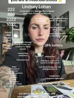 A woman with dark hair and a black shirt sits while facing the camera, surrounded by handwritten and printed text overlays. The overall composition is a selfie-style shot, utilizing natural lighting.