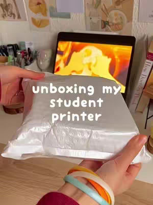 The cover image shows hands holding a package with the text overlay 'unboxing my student printer'. The background has a mix of items reflecting a study room.
