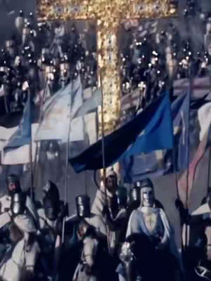 A historical image depicting a religious procession or battle scene, dominated by numerous figures with medieval armor and weaponry, with flags and a large cross in the background. The composition is busy, full of movement, with muted colors and an aged, documentary style.