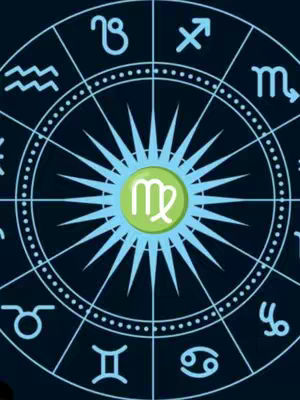 The cover image displays a stylized zodiac wheel against a dark blue background. The wheel features various zodiac symbols along its outer rim. At the center, inside a pale green circle, is the Virgo symbol. The design has a celestial aesthetic with light blue starbursts emanating from the center. 