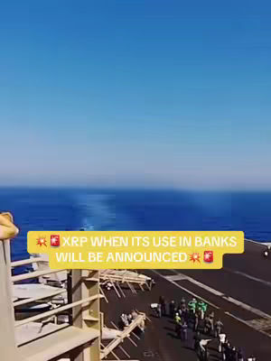 A vertical video thumbnail shows a view from an aircraft carrier. In the background, a vast blue ocean meets a bright blue sky. The aircraft carrier deck is visible, with personnel in green uniforms. A yellow rectangular overlay with text is present in the foreground.