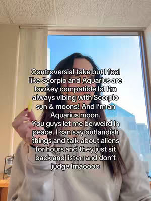 The cover image is a selfie-style shot featuring a person in an indoor setting. The person is positioned in the foreground, with the upper body visible and the background of the setting slightly out of focus showing a window behind them. The person's expression is neutral, but the overlaid text suggests a conversational and possibly controversial topic related to zodiac signs.