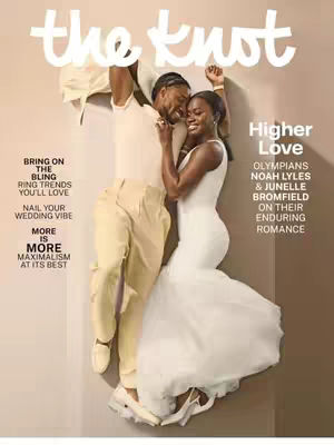 Cover of The Knot magazine featuring a couple, Noah Lyles and Junelle Bromfield, in a romantic embrace. They are leaning against a neutral background, illuminated by soft lighting. The magazine title is prominently displayed at the top.