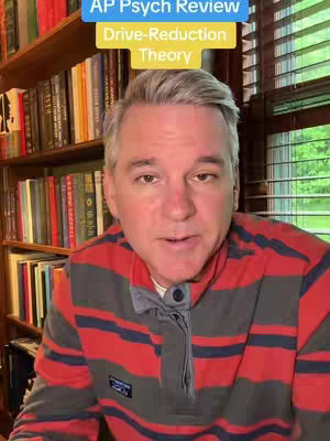 A man with graying hair and a striped shirt sits in front of a bookshelf, a text overlay at the top of the image. The man is looking at the camera and talking.