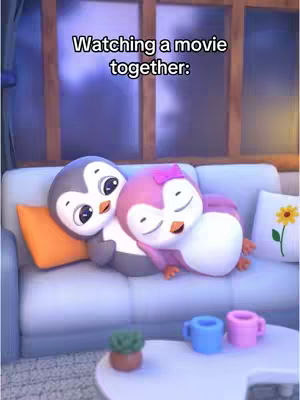 The image features a cozy scene of two cartoon penguins cuddling on a light blue sofa. One penguin is gray and the other is pink. An orange pillow and a decorative pillow with a yellow flower rest on the sofa. A white coffee table holds blue and pink mugs and a small potted plant. The background shows a window with a view and warm lighting.