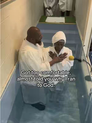 The cover image shows a baptism scene. Two people are in a pool of water; one is a man wearing a white robe, and the other is a woman who is wearing a white robe and hair covering. The man is assisting the woman. The image has a medium shot with good lighting.