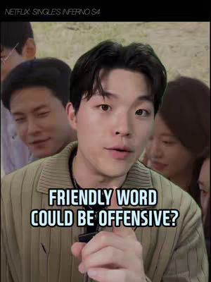 A man in a striped shirt is centered, looking towards the camera in a medium shot. Behind him are indistinct figures, adding depth to the scene. The text overlay states "FRIENDLY WORD COULD BE OFFENSIVE?"