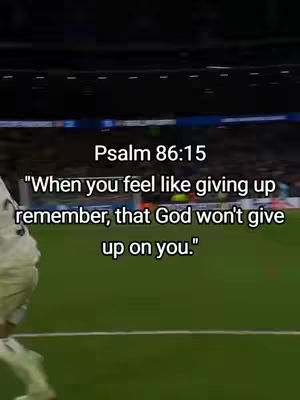 The image shows a soccer field with the blurry background of stadium seating. In the foreground, text is overlaid, quoting a Bible verse about not giving up.